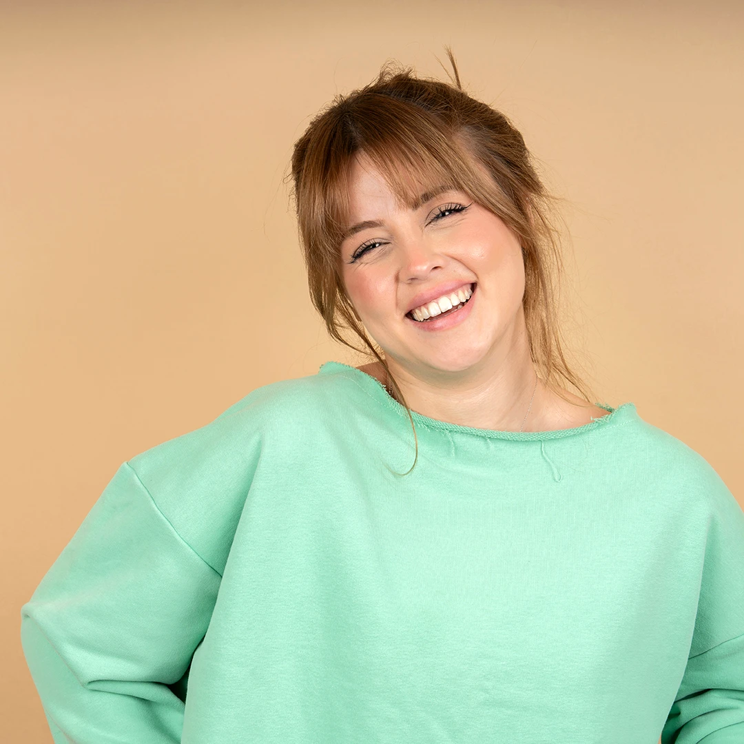 Smiling Young Woman In Green Sweater
