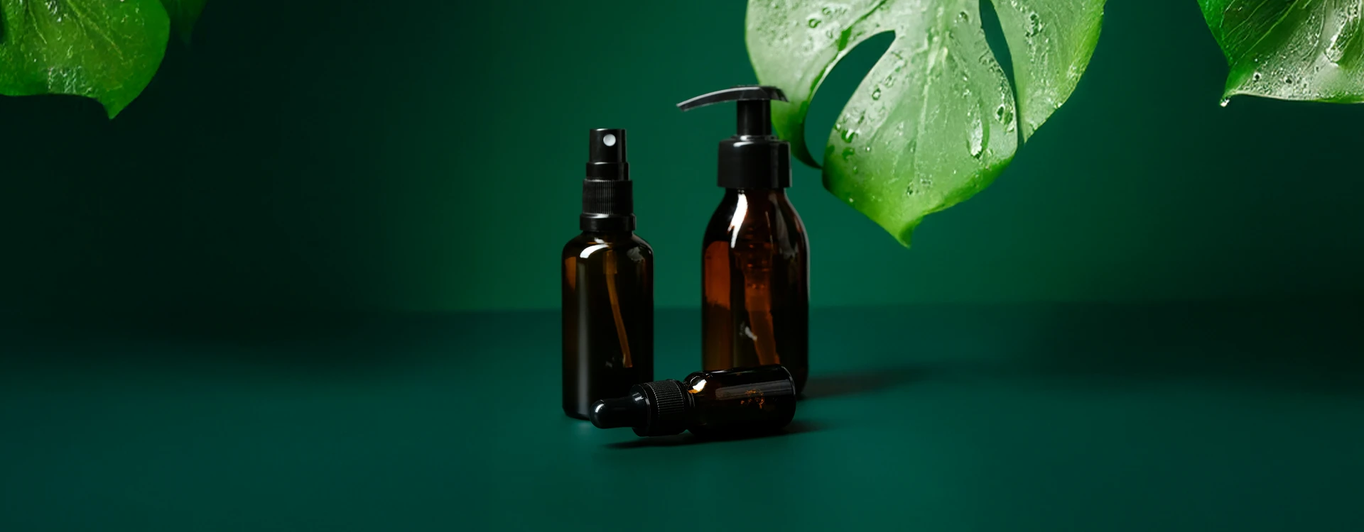 Brown Plastic Bottles On A Green Background